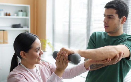 doctor-helping-patient-during-rehabilitation (1) (2)