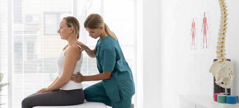 young-physiotherapist-helping-patient-with-back-problems (2)