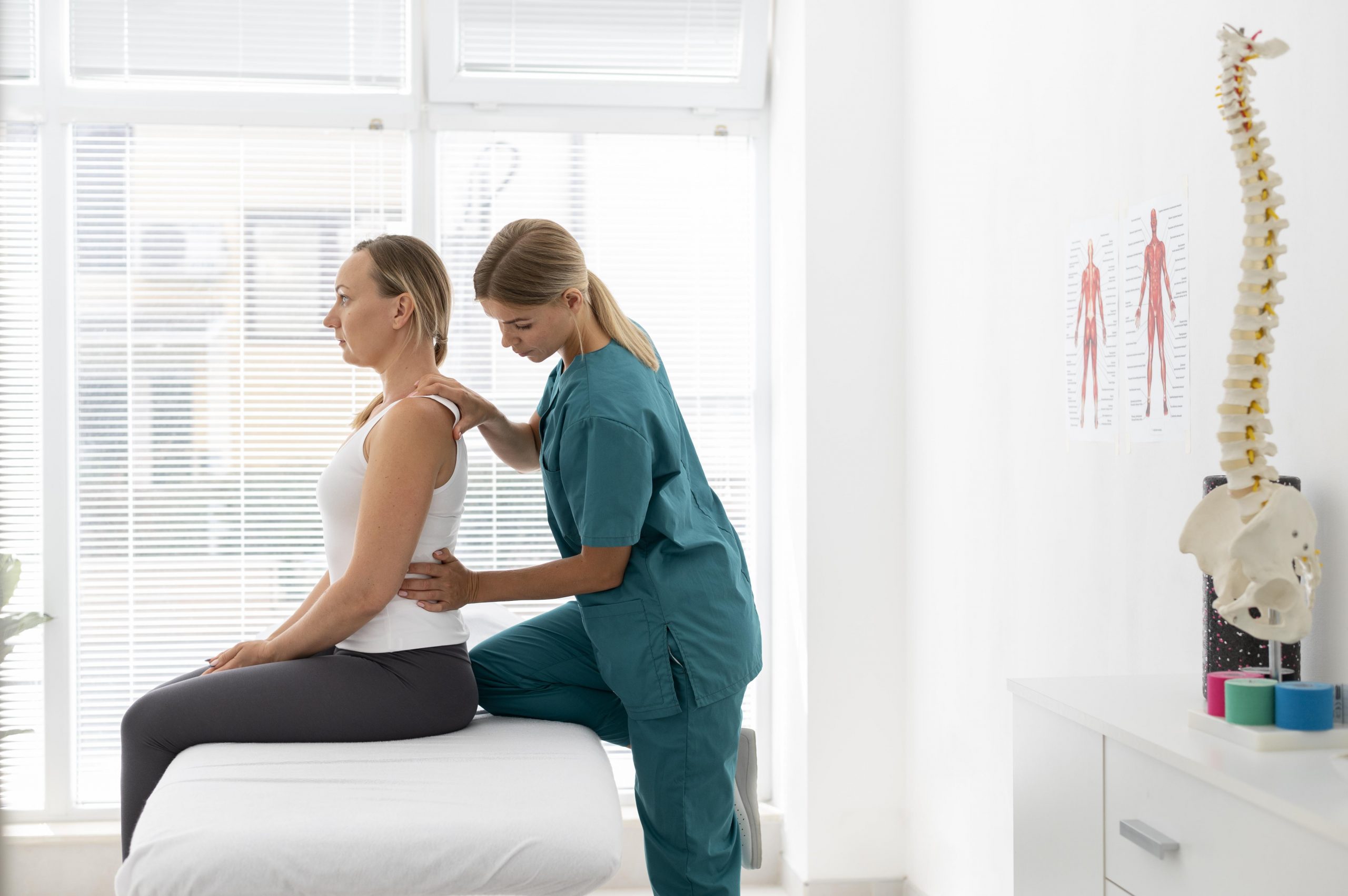 young-physiotherapist-helping-patient-with-back-problems (2)