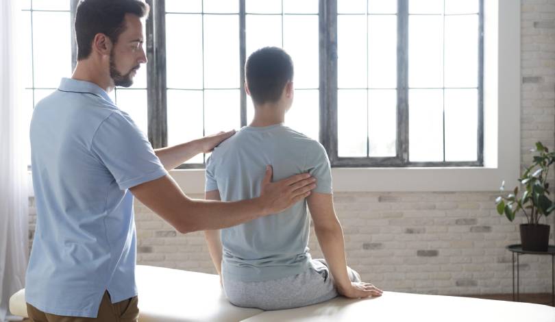 Patient receiving manual therapy for back pain treatment