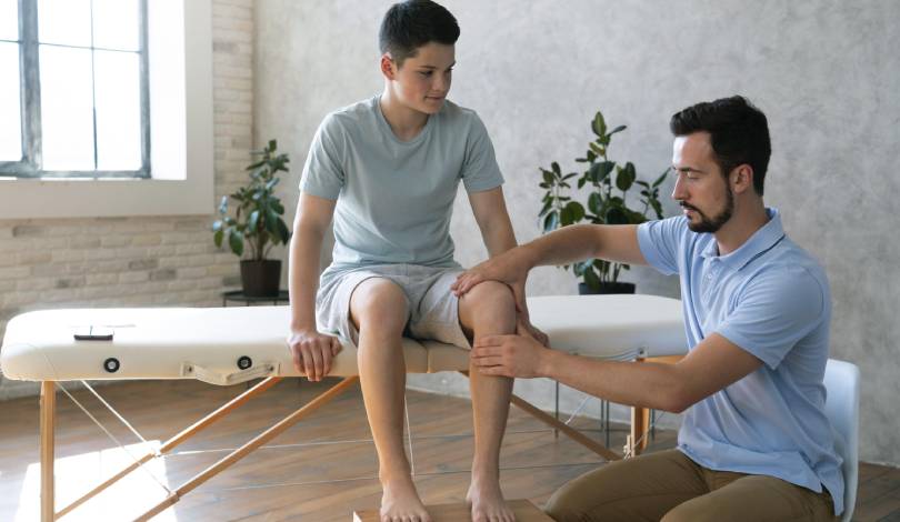 Patient receiving manual therapy for knee joint pain relief
