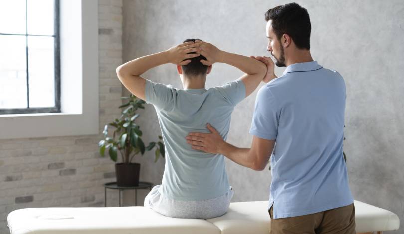 Physiotherapist guiding shoulder pain exercises for recovery.