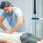 Physiotherapist assisting a patient with spinal physiotherapy treatment.