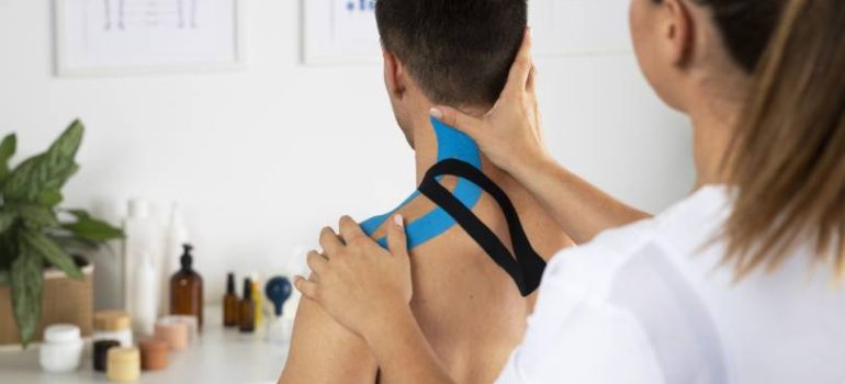 Physiotherapist guiding a patient through rotator cuff injury physiotherapy.