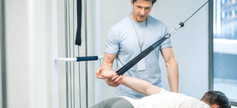 Shoulder physiotherapy session using pulley and bands