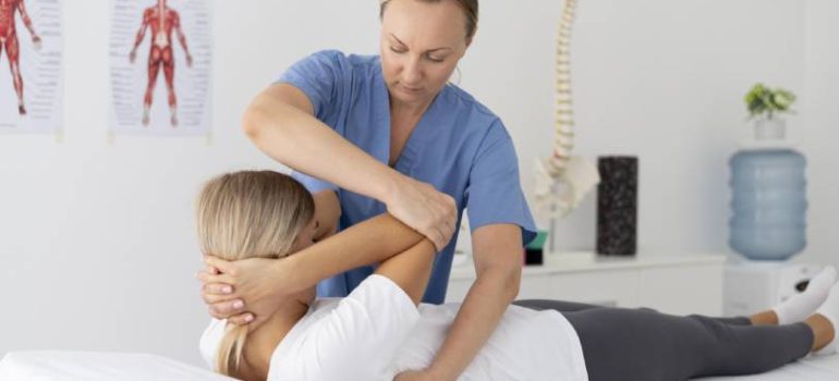 Physiotherapist performing cervical mobilisation on patient