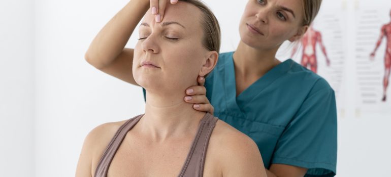 physiotherapist-helping-patient-her-clinic