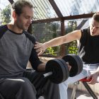 medium-shot-friends-training-together-with-dumbbells