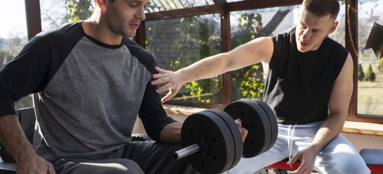 medium-shot-friends-training-together-with-dumbbells