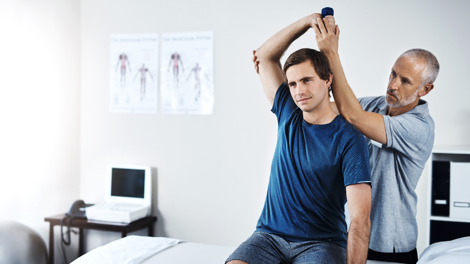 physiotherapist-guiding-passive-range-of-motion-exercises-for-a-patient-with-a-fractured-humerus