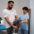 physiotherapist-applying-manual-mobilization-to-a-patients-ankle-joint