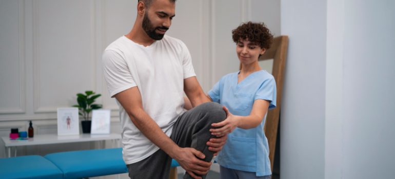 physiotherapist-applying-manual-mobilization-to-a-patients-ankle-joint