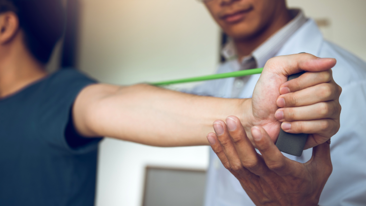 physiotherapist-applying-therapeutic-taping-for-physiotherapy-for-tennis-elbow