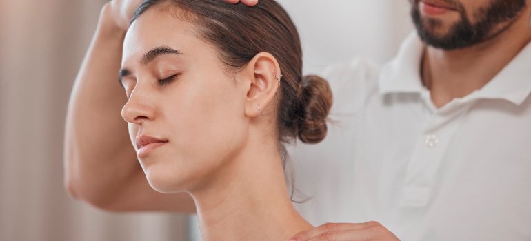 patient-demonstrating-deep-cervical-flexor-strengthening-exercise-guided-by-a-neck-physio