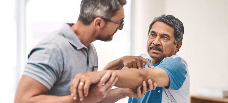 physiotherapist-applying-gentle-manual-cervical-mobilization-for-spondylosis