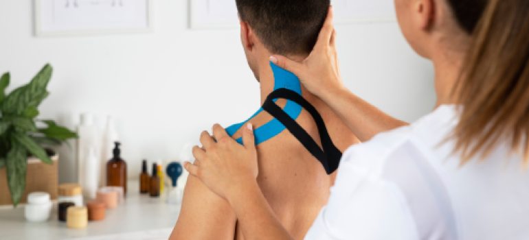 physiotherapist-applying-therapeutic-taping-for-physiotherapy-for-tennis-elbow