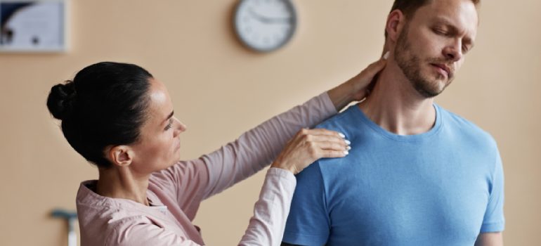physiotherapist-performing-manual-mobilization-on-a-patients-cervical-spine-for-stiff-neck-physiotherapy