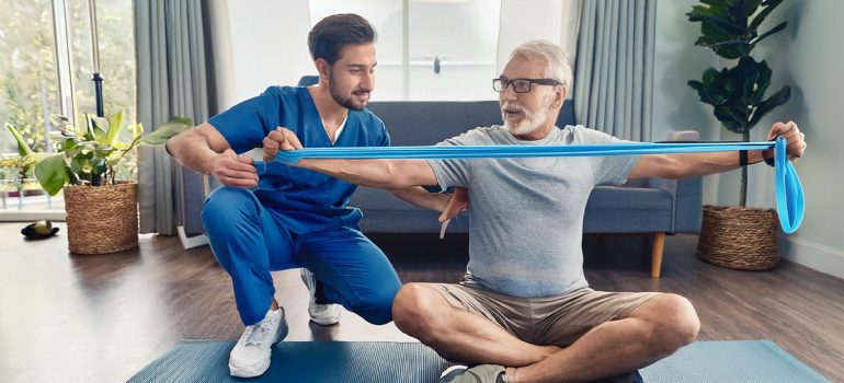 physiotherapist-guiding-passive-range-of-motion-exercises-for-a-patient-with-a-fractured-humerus