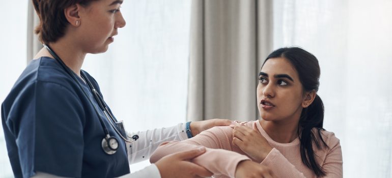 physiotherapist-performing-gentle-passive-range-of-motion-on-a-patients-elbow-joint