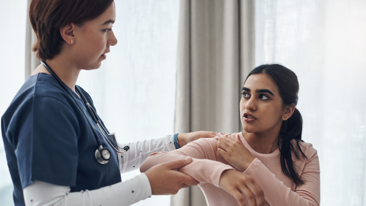 physiotherapist-performing-gentle-passive-range-of-motion-on-a-patients-elbow-joint