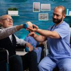 physiotherapist-guiding-passive-range-of-motion-exercises-for-a-patient-with-a-fractured-humerus