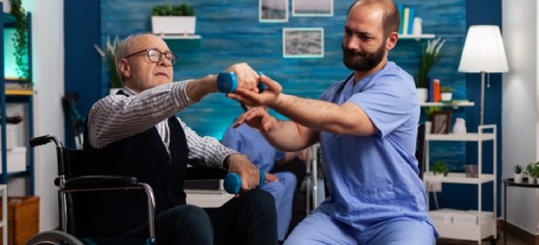 physiotherapist-guiding-passive-range-of-motion-exercises-for-a-patient-with-a-fractured-humerus