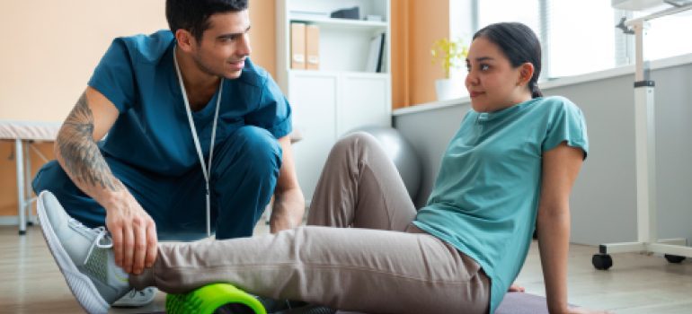 athlete-performing-functional-rehabilitation-exercises-under-the-guidance-of-a-sports-physio