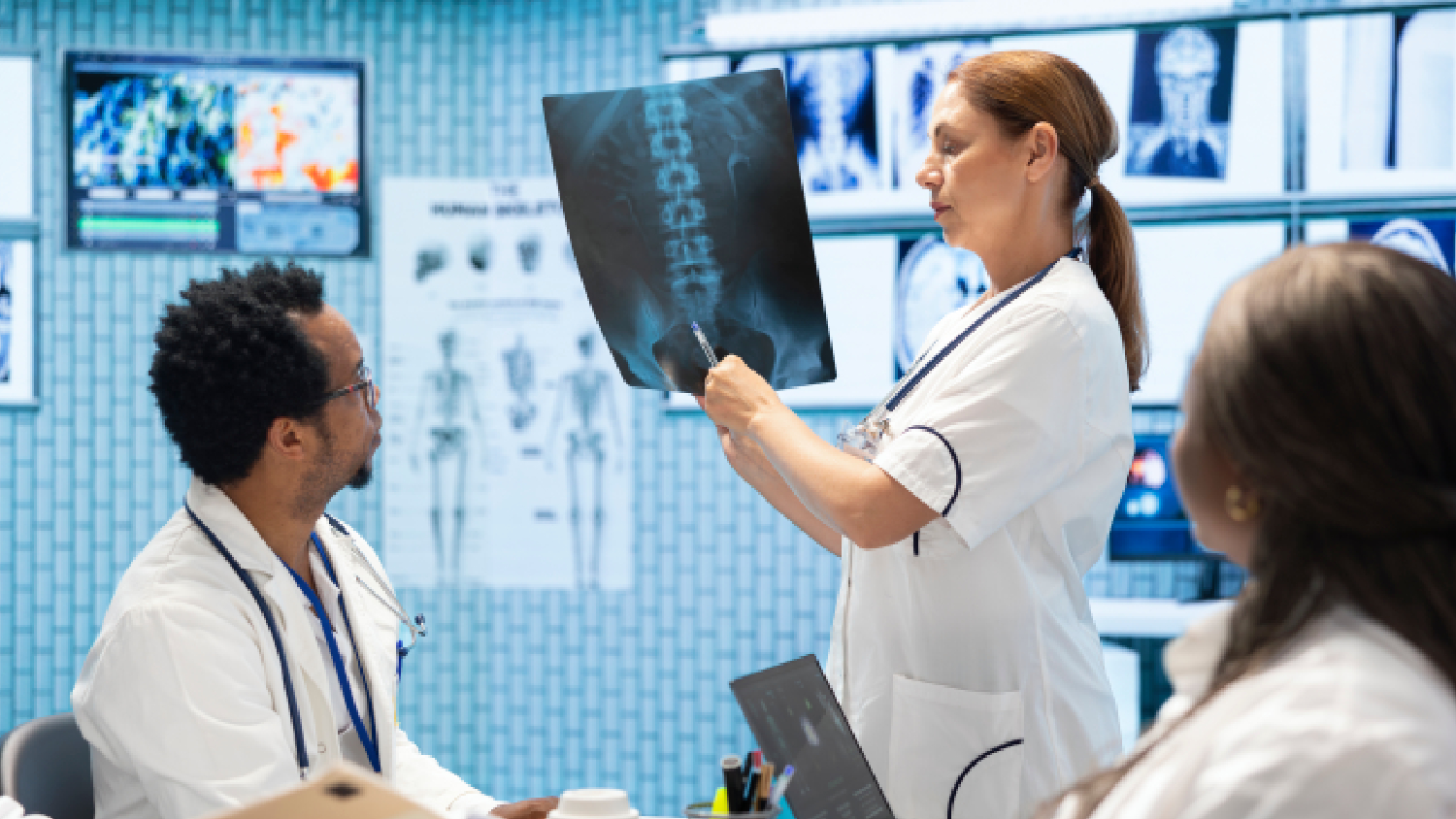 medical-team-including-a-doctor-and-physiotherapist-reviewing-a-patients-spinal-x-ray-together