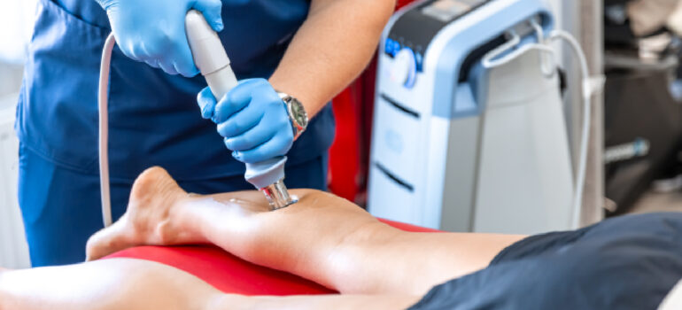 specialist-using-a-handheld-diagnostic-ultrasound-probe-to-scan-a-patients-shoulder-tendons
